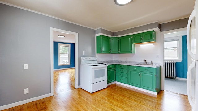 28 Stewart St, Lewiston, ME 04240 - kitchen featuring green cabinetry, white electric stove, light wood-type flooring, light countertops, and radiator heating unit