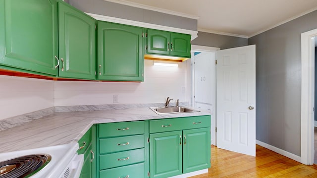 28 Stewart St, Lewiston, ME 04240 - kitchen with stove, light wood-type flooring, light countertops, crown molding, and green cabinetry