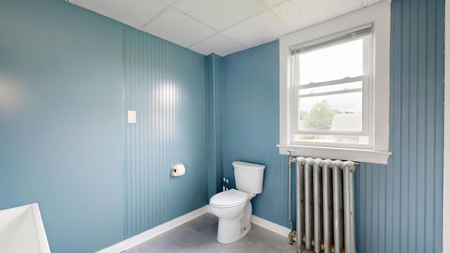 28 Stewart St, Lewiston, ME 04240 - bathroom featuring radiator heating unit, tile patterned floors, and a paneled ceiling