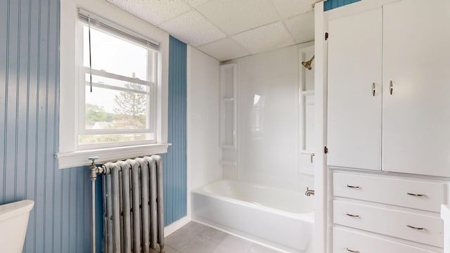 28 Stewart St, Lewiston, ME 04240 - bathroom with radiator heating unit, tile patterned floors, bathtub / shower combination, a drop ceiling, and wallpapered walls