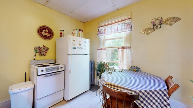 28 Stewart St, Lewiston, ME 04240 - kitchen featuring white appliances and a drop ceiling