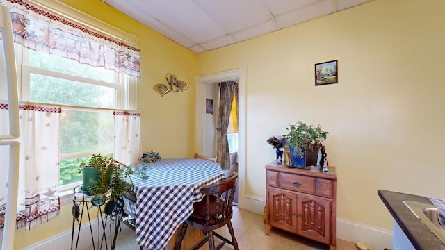 28 Stewart St, Lewiston, ME 04240 - dining area featuring healthy amount of natural light and a paneled ceiling