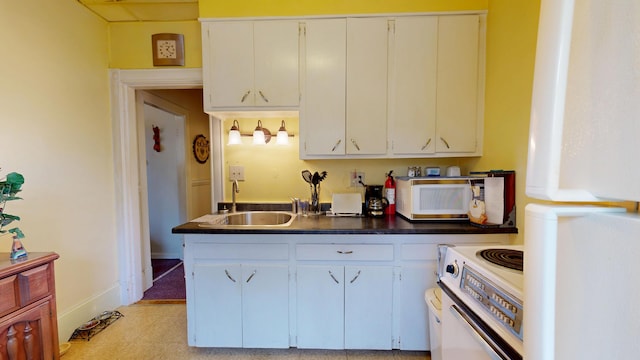 28 Stewart St, Lewiston, ME 04240 - kitchen featuring white appliances, white cabinetry, and dark countertops