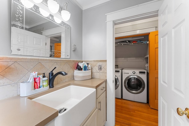 118 Gore Rd, Palermo, ME 04354 - laundry area with separate washer and dryer, light wood-style flooring, and crown molding