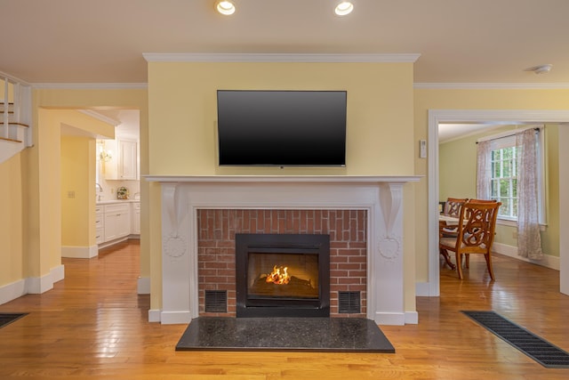 135 State Highway 3, Bar Harbor, ME 04609 - detailed view of wood finished floors, a fireplace, crown molding, and recessed lighting