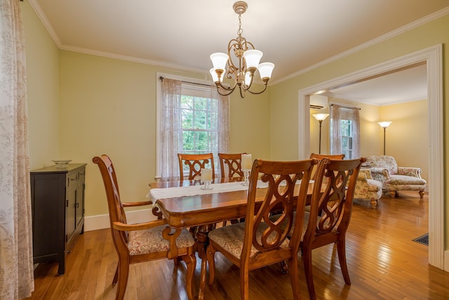 135 State Highway 3, Bar Harbor, ME 04609 - dining room featuring light wood-type flooring, a chandelier, ornamental molding, and a wall mounted air conditioner