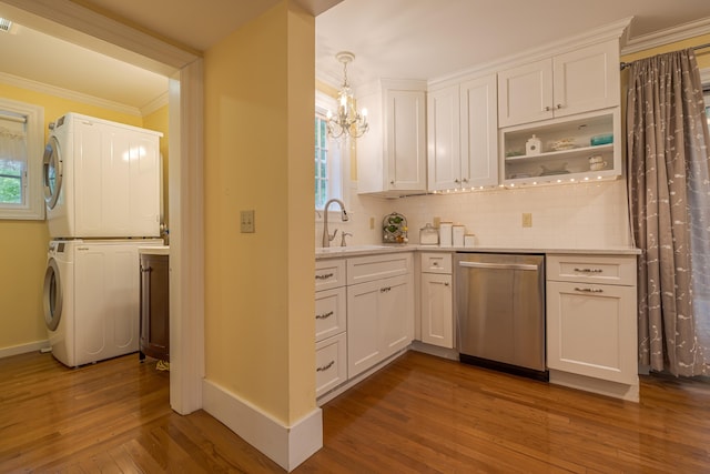 135 State Highway 3, Bar Harbor, ME 04609 - kitchen with stacked washer / drying machine, dark wood-style flooring, dishwasher, crown molding, and tasteful backsplash