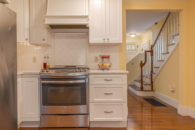 135 State Highway 3, Bar Harbor, ME 04609 - kitchen with stainless steel appliances, white cabinetry, wood finished floors, and decorative backsplash