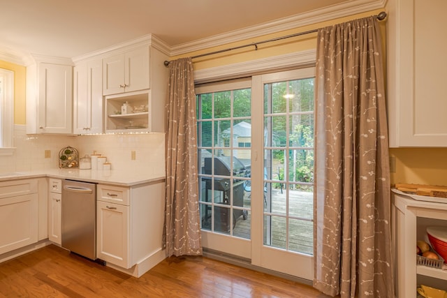 135 State Highway 3, Bar Harbor, ME 04609 - kitchen featuring wood finished floors, decorative backsplash, light countertops, white cabinetry, and ornamental molding