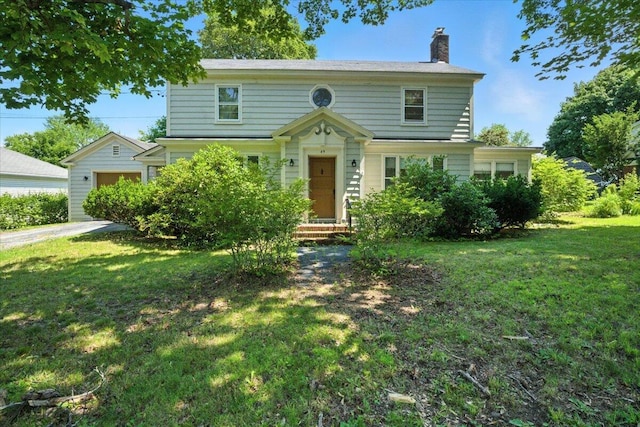 49 Bardwell St, Lewiston, ME 04240 - view of front of home with a chimney, a front yard, and a garage
