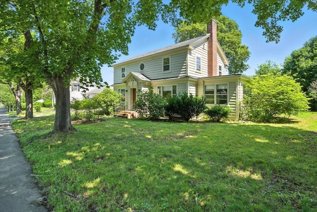 49 Bardwell St, Lewiston, ME 04240 - view of front of property featuring a front lawn and a chimney