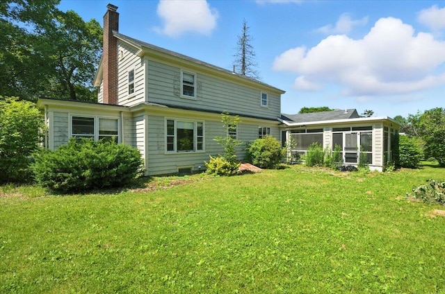 49 Bardwell St, Lewiston, ME 04240 - rear view of property featuring a sunroom, a chimney, and a yard