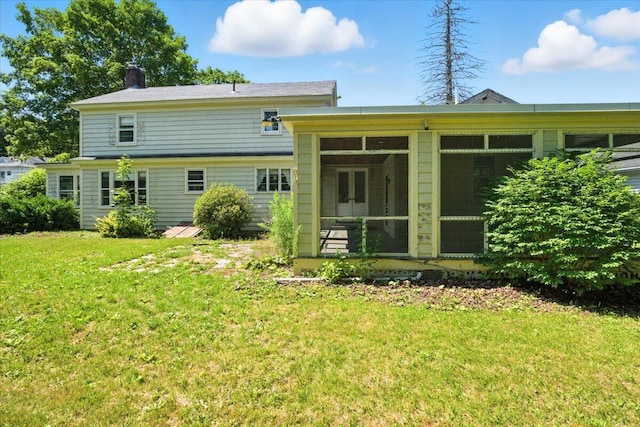 49 Bardwell St, Lewiston, ME 04240 - back of property featuring a sunroom, a yard, and a chimney