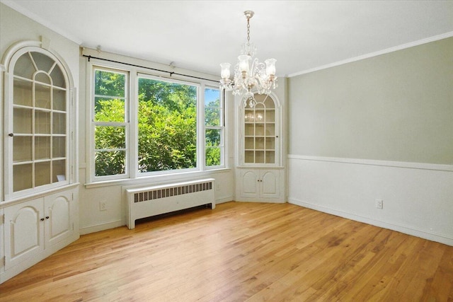 49 Bardwell St, Lewiston, ME 04240 - empty room featuring a chandelier, radiator heating unit, wood finished floors, and crown molding