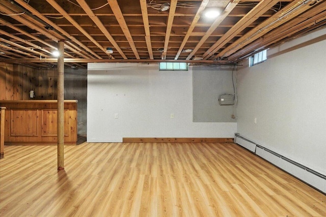 49 Bardwell St, Lewiston, ME 04240 - below grade area with a baseboard radiator and wood finished floors