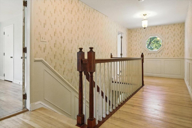 49 Bardwell St, Lewiston, ME 04240 - stairway with wallpapered walls, a decorative wall, wood finished floors, and wainscoting