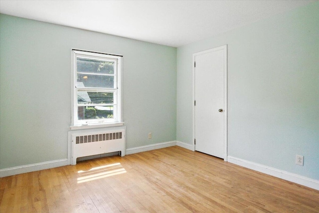 49 Bardwell St, Lewiston, ME 04240 - unfurnished room with radiator heating unit and wood finished floors