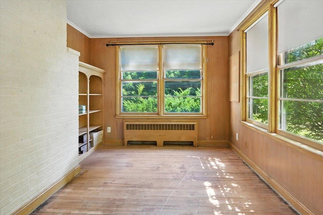 49 Bardwell St, Lewiston, ME 04240 - spare room with radiator heating unit, wood finished floors, built in features, and crown molding