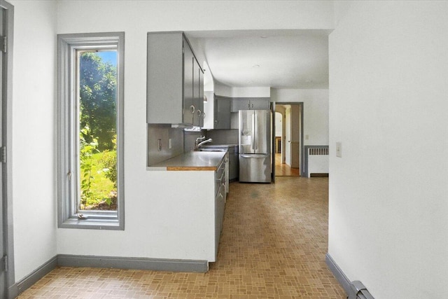 49 Bardwell St, Lewiston, ME 04240 - kitchen featuring gray cabinetry, stainless steel refrigerator with ice dispenser, radiator heating unit, and tile patterned floors