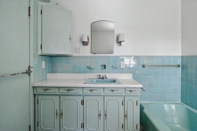 49 Bardwell St, Lewiston, ME 04240 - bathroom with tile walls, vanity, a tub to relax in, and wainscoting
