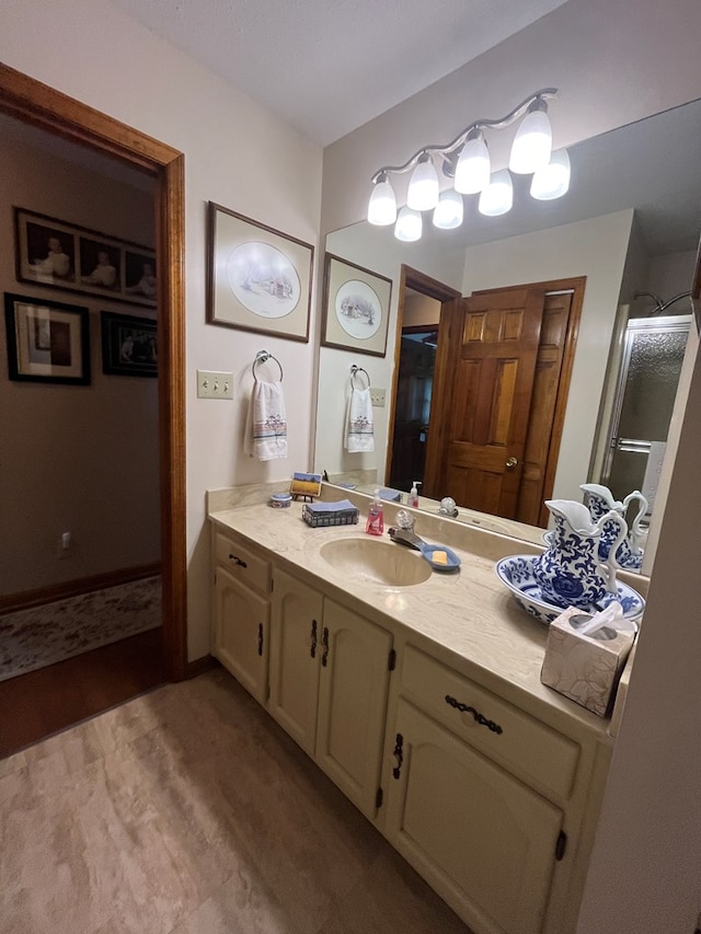 bathroom with walk in shower, vanity, and hardwood / wood-style flooring