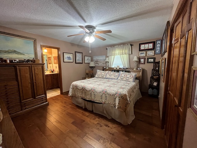 bedroom featuring connected bathroom, wood-type flooring, a textured ceiling, and ceiling fan