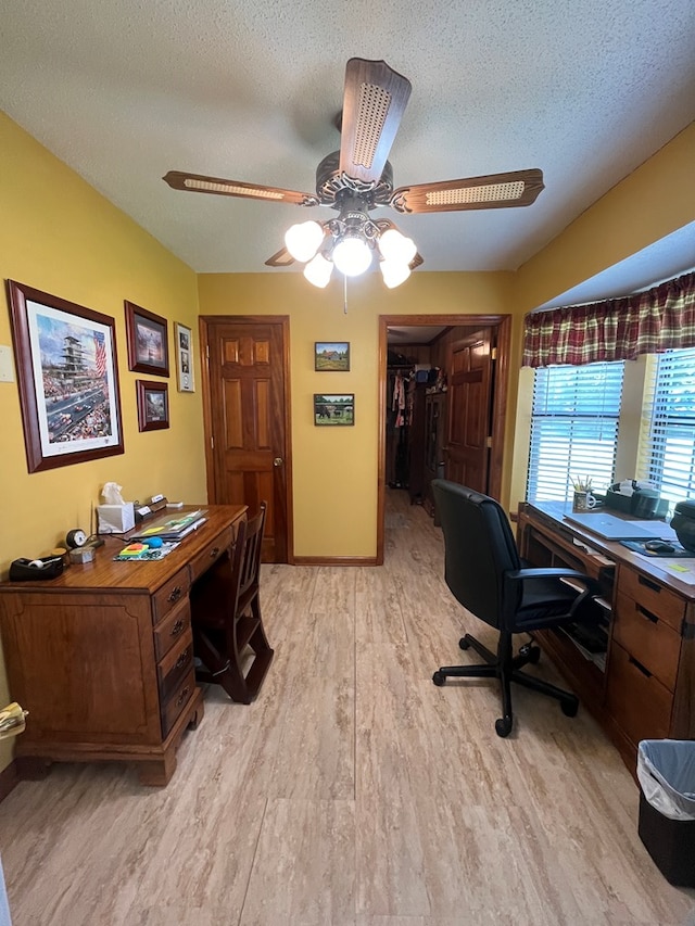 office area featuring ceiling fan, a textured ceiling, and light hardwood / wood-style flooring