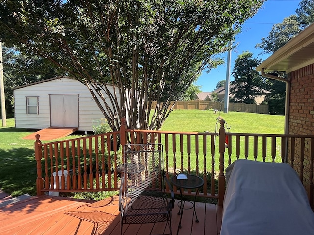 wooden deck featuring a grill, a yard, and a storage shed