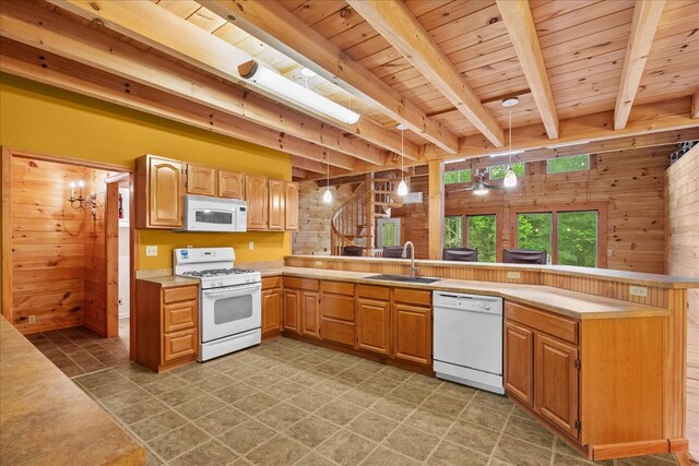 3691 Flagpole Rd, Ellijay, GA 30540 - kitchen with white appliances, a sink, wooden ceiling with exposed beams, wooden walls, and light countertops