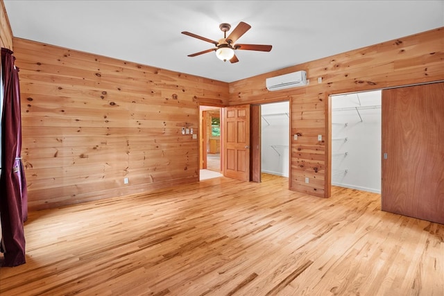 3691 Flagpole Rd, Ellijay, GA 30540 - unfurnished bedroom featuring a wall mounted AC, wood finished floors, wood walls, and ceiling fan