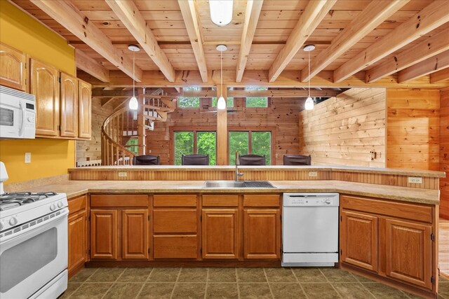3691 Flagpole Rd, Ellijay, GA 30540 - kitchen with white appliances, a sink, wood ceiling with exposed beams, wood walls, and light countertops