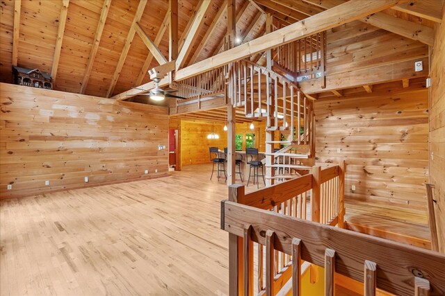 3691 Flagpole Rd, Ellijay, GA 30540 - hallway featuring an upstairs landing, wooden walls, high vaulted ceiling, wooden ceiling with exposed beams, and wood finished floors