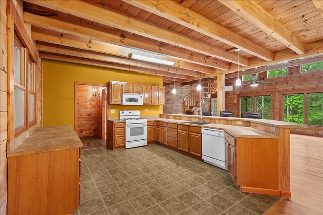 3691 Flagpole Rd, Ellijay, GA 30540 - kitchen with white appliances, a peninsula, a sink, wood ceiling with exposed beams, and light countertops