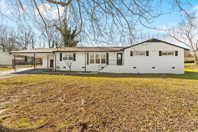 ranch-style house featuring driveway, an attached carport, crawl space, and a front lawn