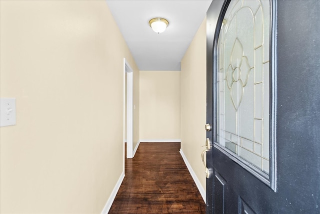 corridor featuring wood finished floors and baseboards