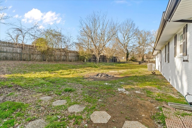 view of yard with cooling unit and fence