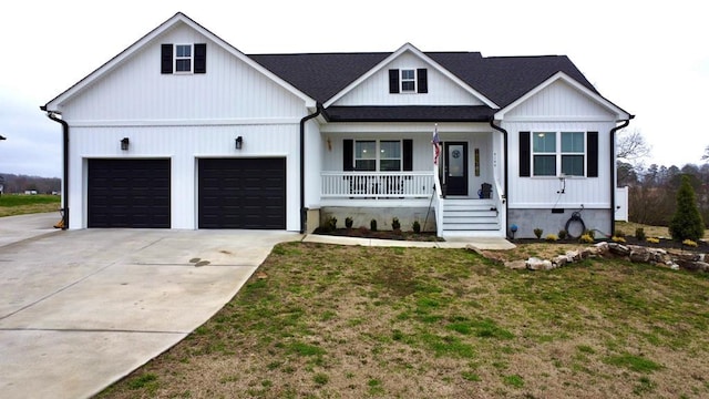 modern inspired farmhouse with a porch, a garage, and a front lawn