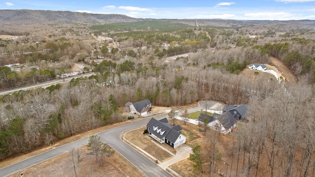 drone / aerial view with a mountain view and a view of trees