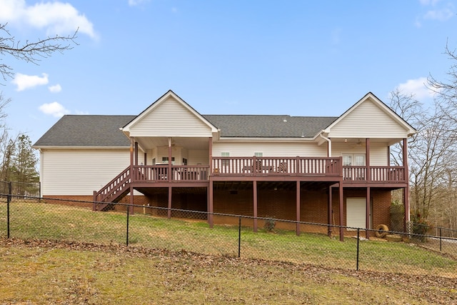 rear view of property featuring a lawn, stairway, a ceiling fan, fence private yard, and a wooden deck