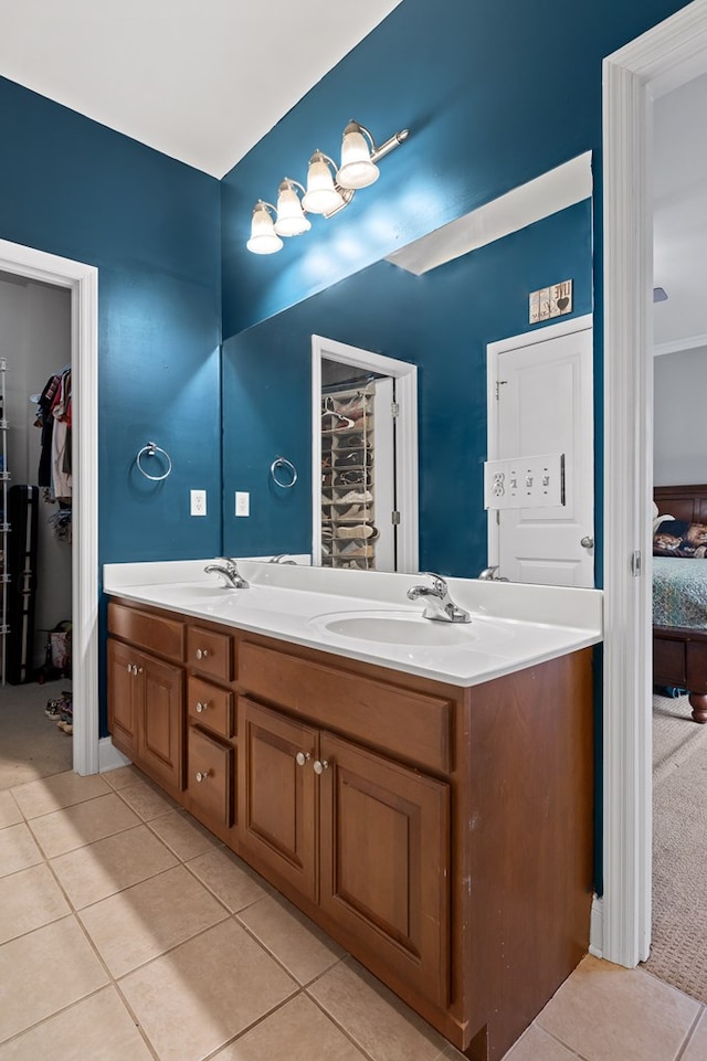 full bath featuring tile patterned flooring, a sink, and double vanity