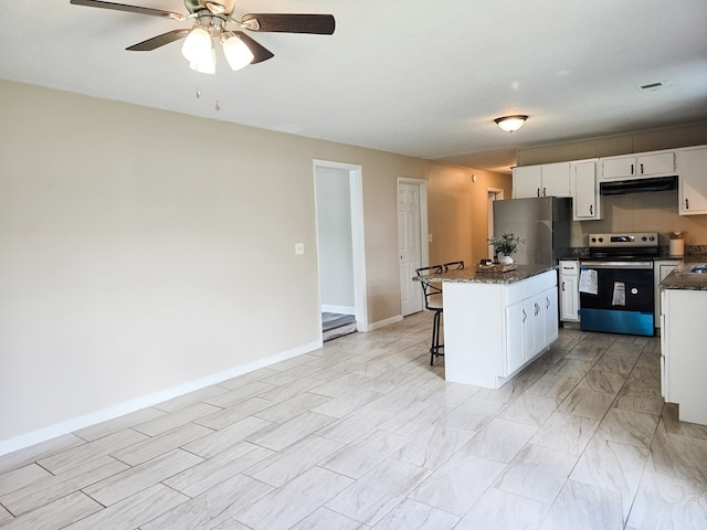 106 Santa Fe Trl NW, Dalton, GA 30721 - kitchen with appliances with stainless steel finishes, under cabinet range hood, white cabinetry, a breakfast bar, and a center island