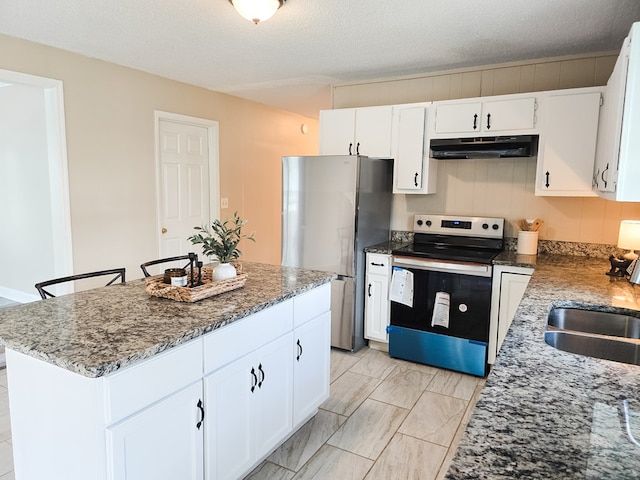 106 Santa Fe Trl NW, Dalton, GA 30721 - kitchen featuring range with electric stovetop, under cabinet range hood, freestanding refrigerator, stone countertops, and a textured ceiling