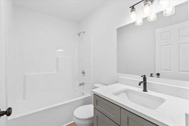 full bathroom featuring toilet, washtub / shower combination, and vanity
