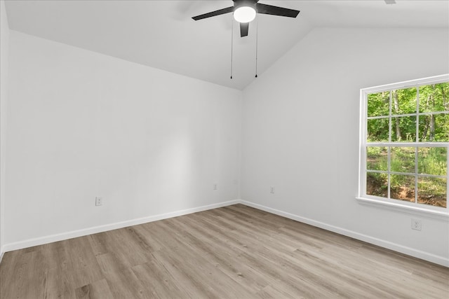 spare room featuring plenty of natural light, a ceiling fan, lofted ceiling, and wood finished floors