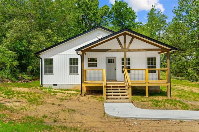 view of front facade with a wooden deck and crawl space