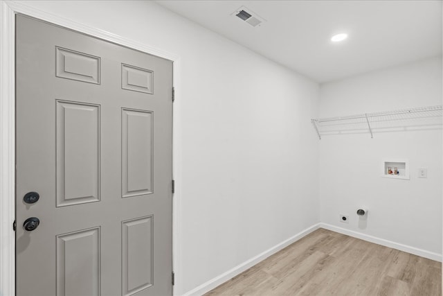 clothes washing area featuring laundry area, washer hookup, light wood-style flooring, hookup for an electric dryer, and visible vents