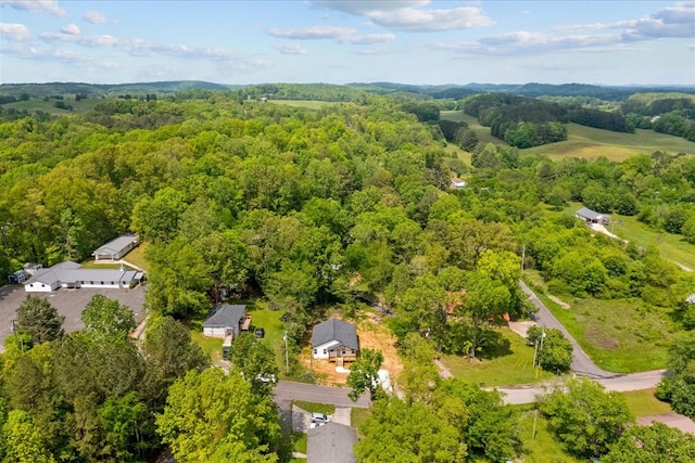 birds eye view of property with a wooded view