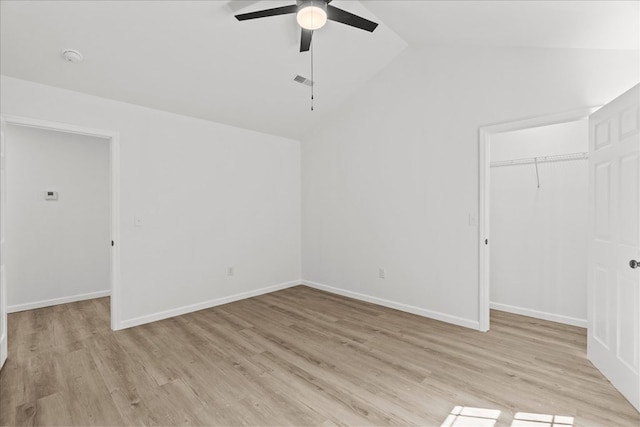 empty room with ceiling fan, visible vents, baseboards, light wood finished floors, and lofted ceiling