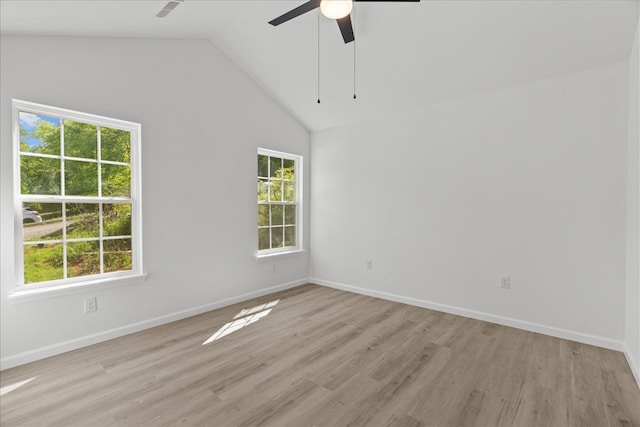 spare room with a healthy amount of sunlight, ceiling fan, and light wood-style floors