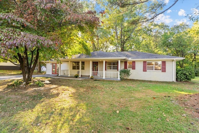 ranch-style house with a front yard and covered porch